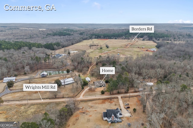 birds eye view of property with a rural view