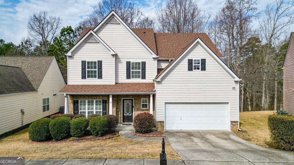 view of front property featuring a garage and a front lawn