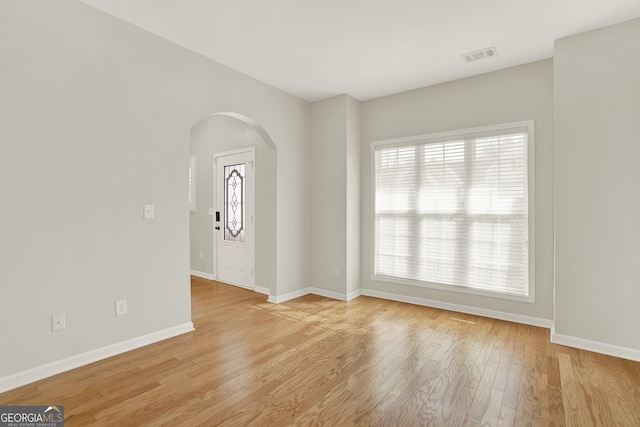 spare room with a healthy amount of sunlight and light hardwood / wood-style floors