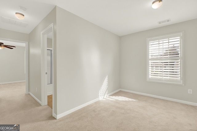 unfurnished room featuring ceiling fan and light carpet