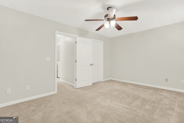 unfurnished bedroom featuring light carpet and ceiling fan