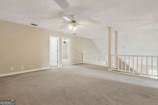 bonus room featuring ceiling fan, carpet floors, and a textured ceiling