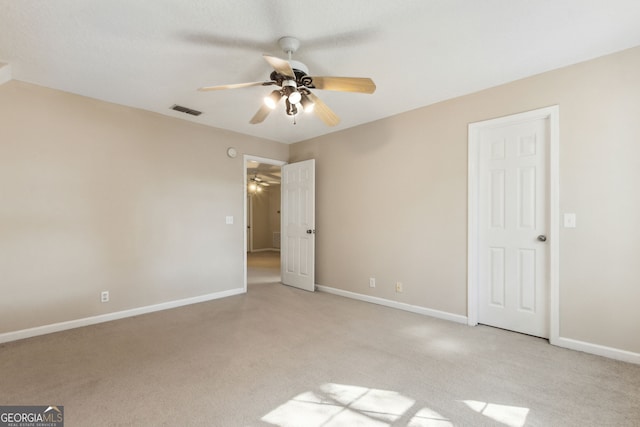 unfurnished bedroom with light carpet and ceiling fan