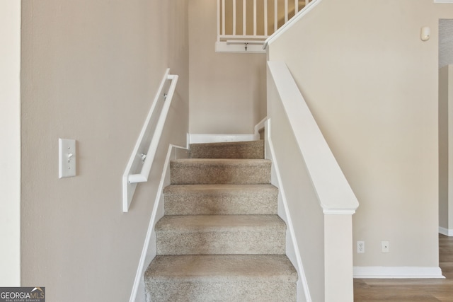 stairs featuring hardwood / wood-style floors