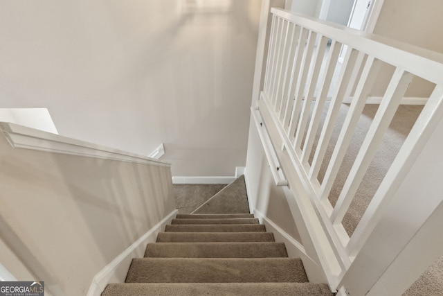 staircase featuring carpet flooring