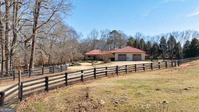 view of yard featuring a rural view and fence