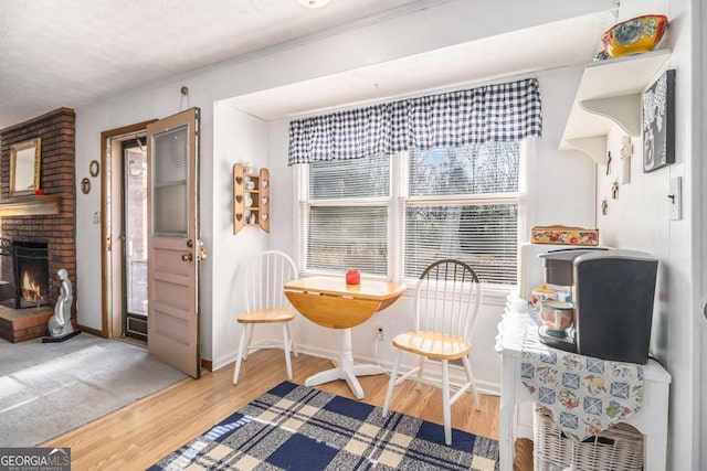 dining area with a brick fireplace and hardwood / wood-style floors