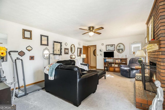 carpeted living room featuring a brick fireplace and ceiling fan