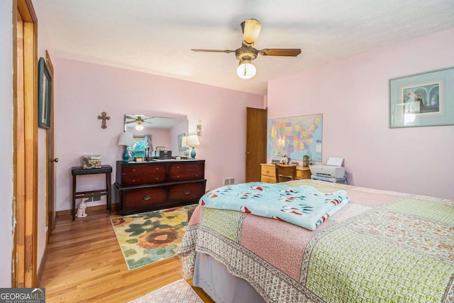 bedroom with ceiling fan and light wood-type flooring