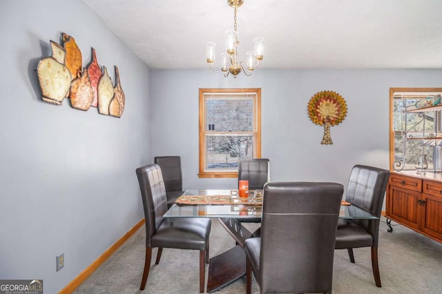 dining space featuring light carpet and a notable chandelier