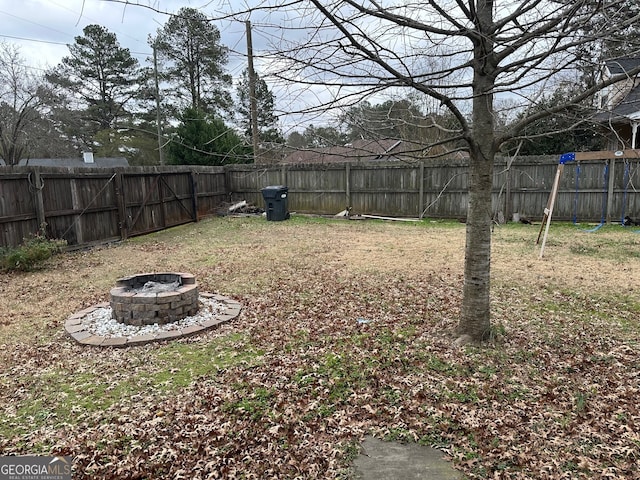 view of yard with an outdoor fire pit