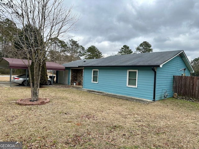 view of front facade featuring a front lawn and a carport