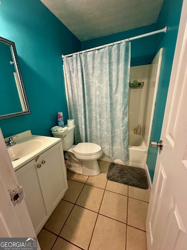 full bathroom featuring tile patterned floors, toilet, shower / tub combo, a textured ceiling, and vanity