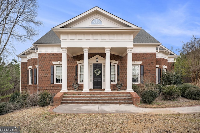 neoclassical / greek revival house featuring covered porch