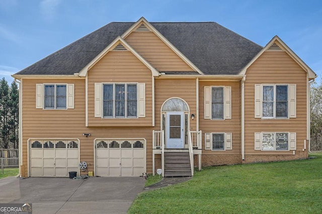 raised ranch with a garage and a front lawn