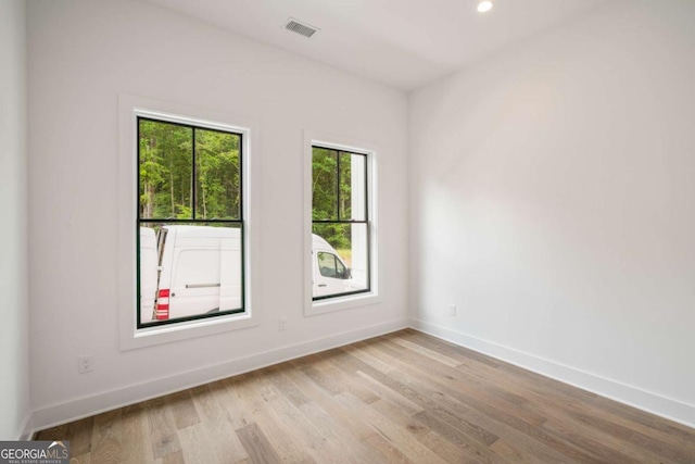 unfurnished room with light wood-type flooring