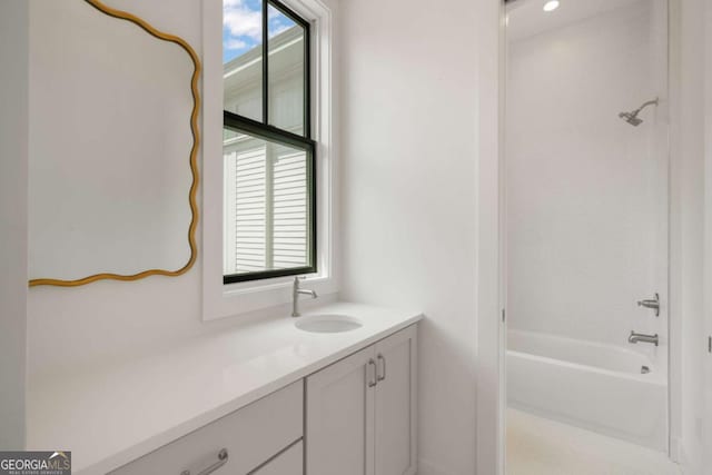 bathroom featuring vanity, plenty of natural light, and bathtub / shower combination