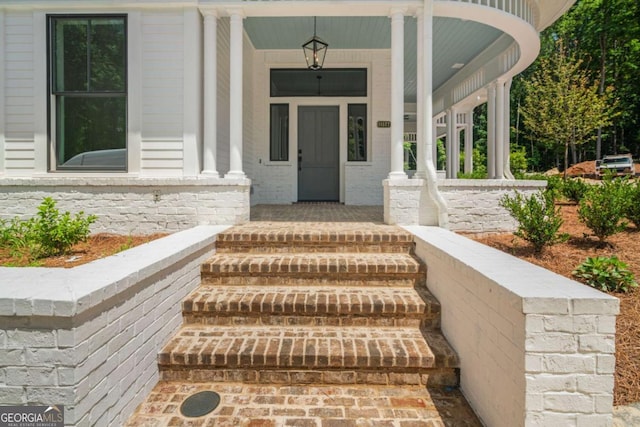 doorway to property featuring covered porch