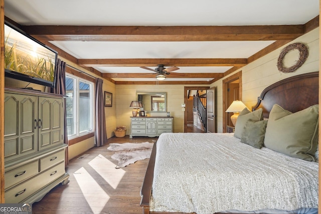 bedroom featuring beam ceiling and light hardwood / wood-style floors