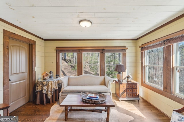 living room with wood-type flooring and wooden walls