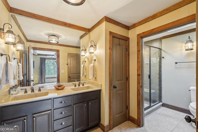 bathroom with vanity, an enclosed shower, crown molding, and toilet