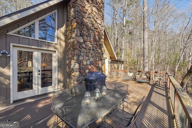 wooden terrace featuring grilling area and french doors