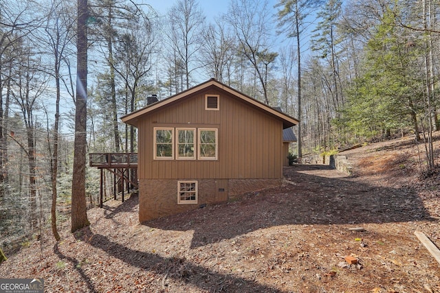 view of property exterior featuring a wooden deck