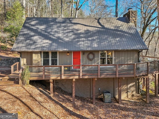 view of front of home with cooling unit and a wooden deck