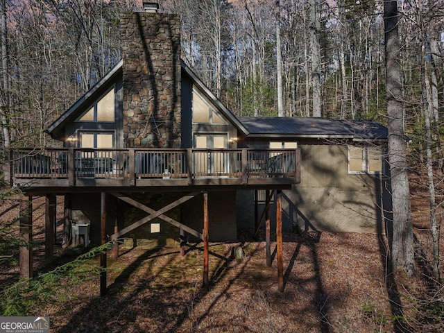 rear view of property with a wooden deck