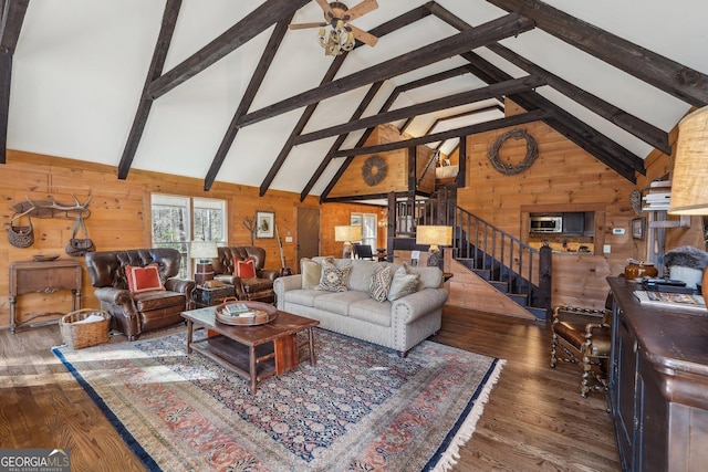 living room featuring high vaulted ceiling, dark wood-type flooring, and wooden walls