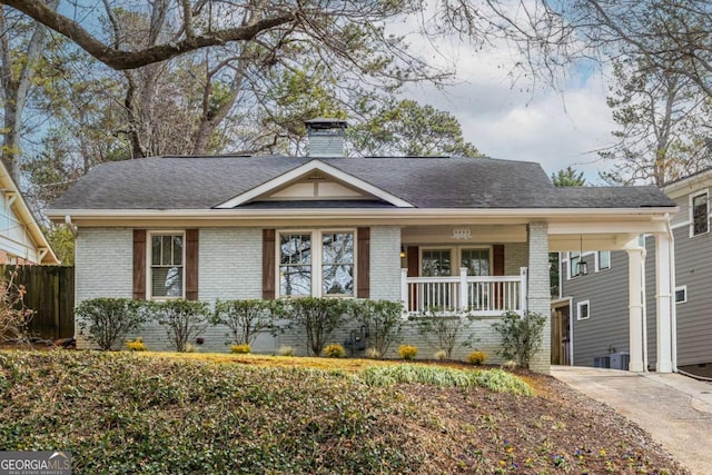 single story home featuring cooling unit and covered porch