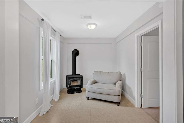 sitting room featuring a wood stove