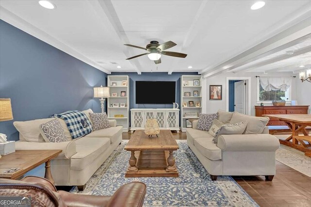 living room with beamed ceiling, ceiling fan with notable chandelier, and dark hardwood / wood-style flooring