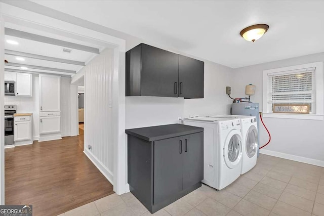 laundry room with washing machine and dryer and light tile patterned flooring