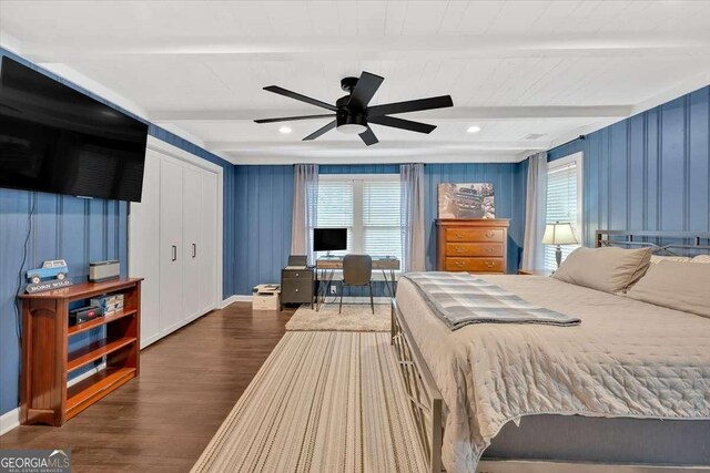 bedroom with beam ceiling, dark wood-type flooring, and ceiling fan