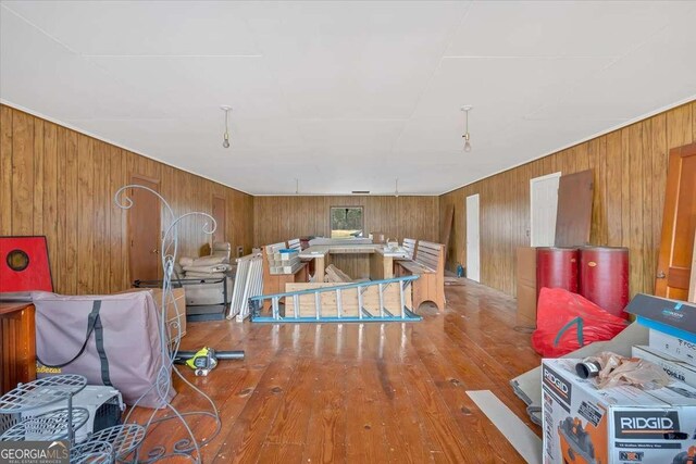 interior space featuring hardwood / wood-style floors and wooden walls