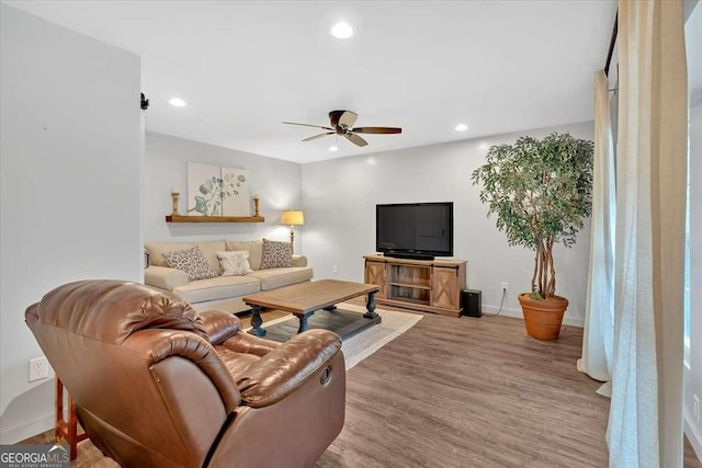 living room with hardwood / wood-style floors and ceiling fan