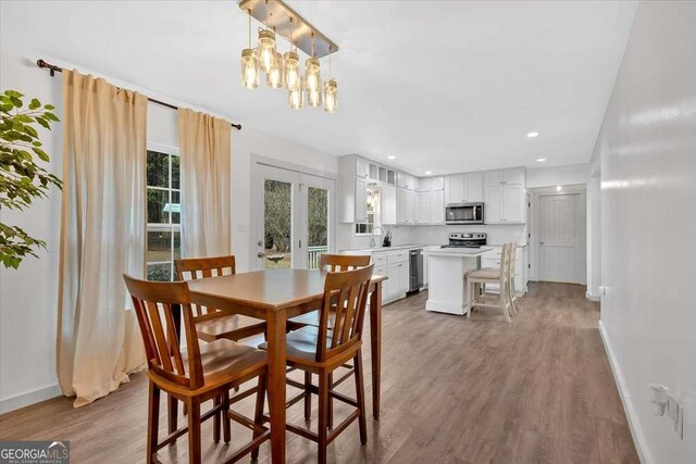 dining space featuring hardwood / wood-style flooring and sink