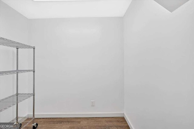 unfurnished room with dark hardwood / wood-style floors