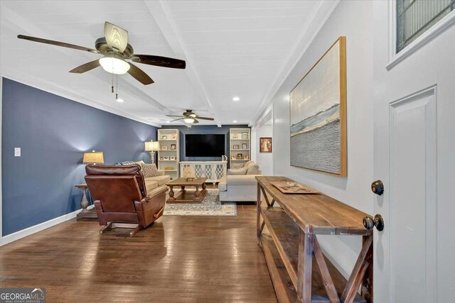 living room with ceiling fan, dark hardwood / wood-style floors, beam ceiling, and built in shelves