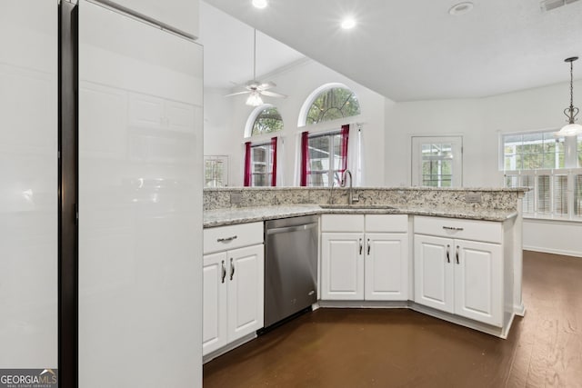 kitchen with stainless steel dishwasher, light stone countertops, sink, and white cabinets