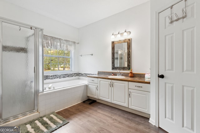 bathroom with vanity, wood-type flooring, and shower with separate bathtub