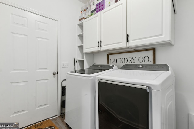 washroom with separate washer and dryer, hardwood / wood-style floors, and cabinets