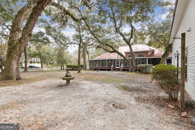 view of yard featuring a sunroom