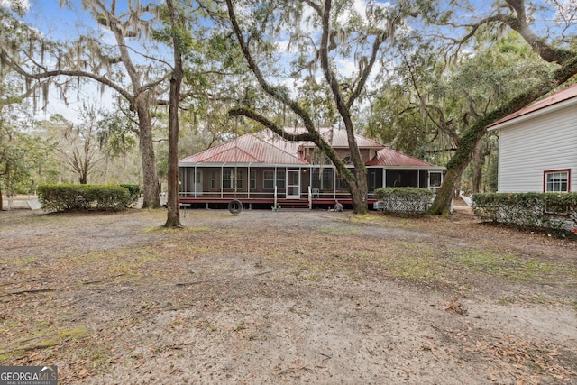 view of front of home featuring a sunroom