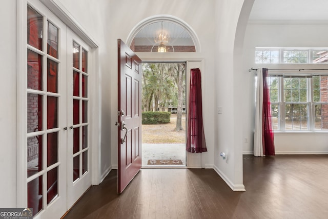 foyer entrance with dark wood-type flooring and french doors