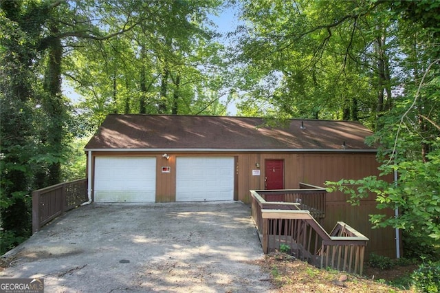 view of front of home with a garage and an outdoor structure