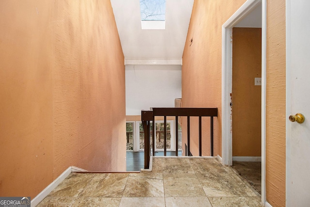 stairway featuring a skylight