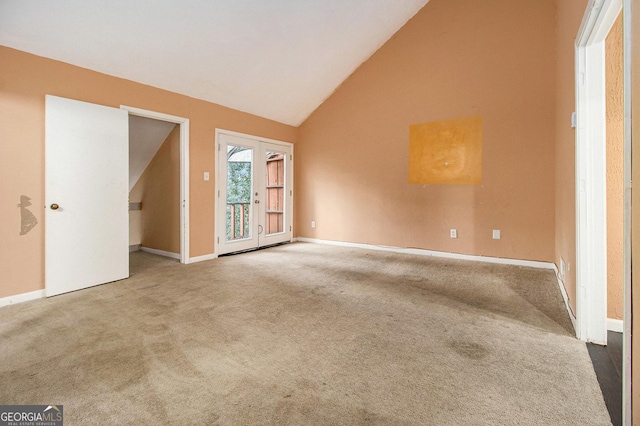 unfurnished room featuring carpet flooring and high vaulted ceiling