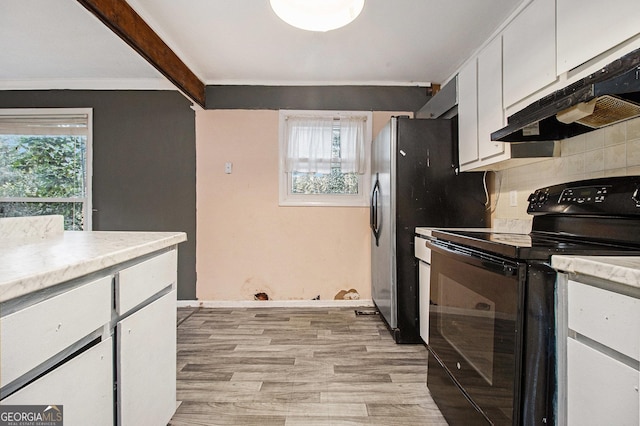 kitchen with beam ceiling, light hardwood / wood-style flooring, black range with electric stovetop, decorative backsplash, and white cabinets